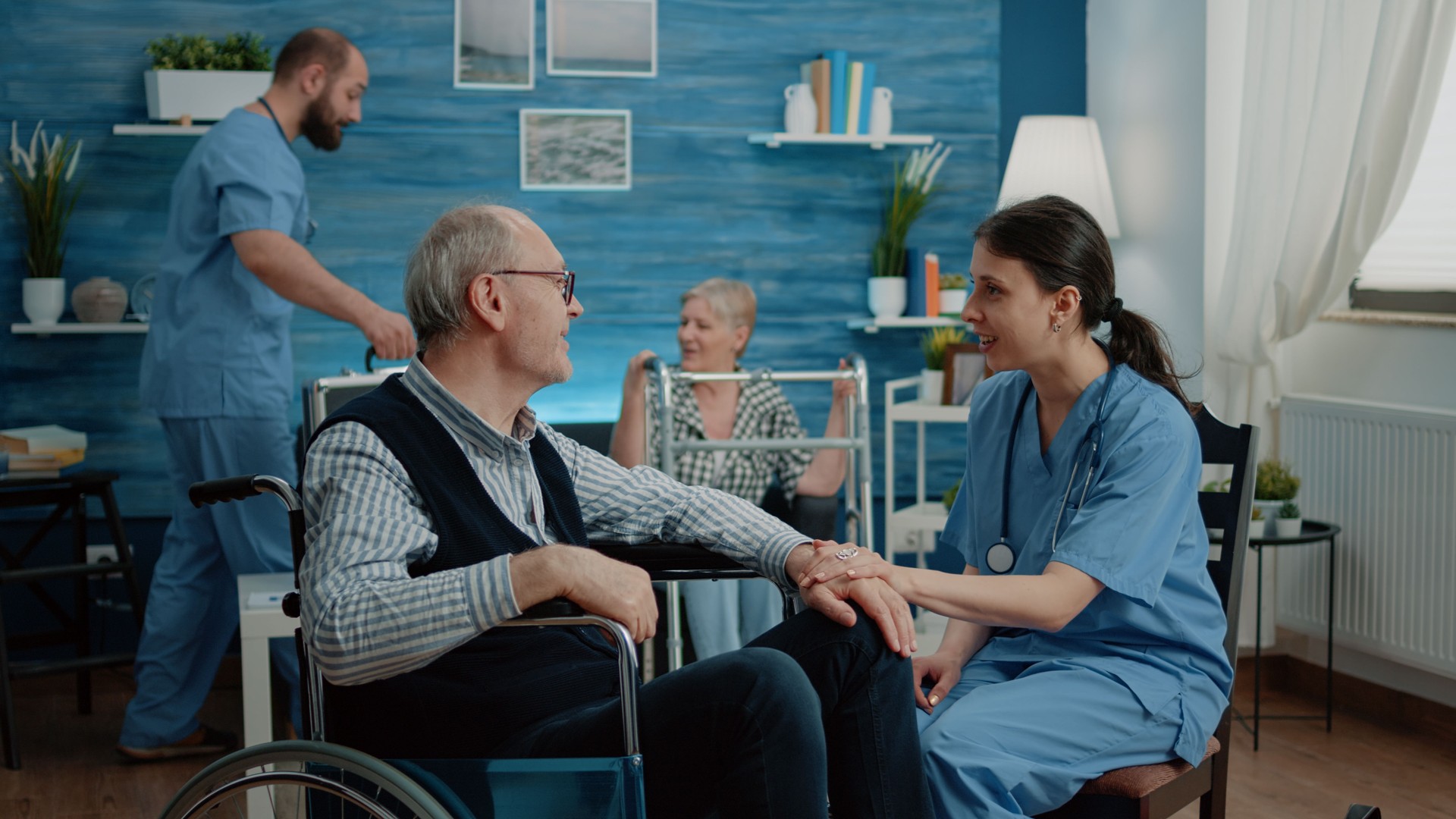 Nurse giving assistance to retired man with disability