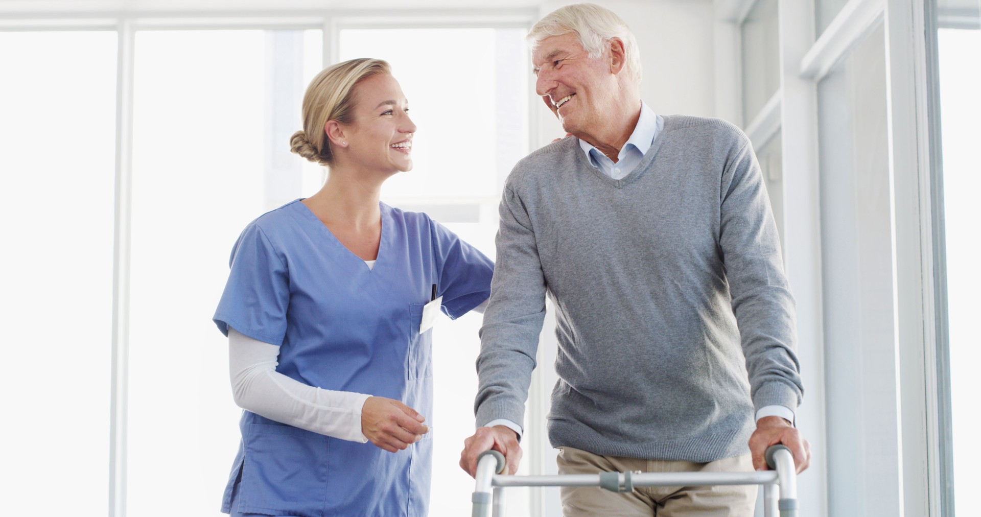 Happy nurse, senior and walker with support for healthcare, assistance or help at hospital. Elderly patient, caregiver or doctor with smile for assisted living or person with a disability at clinic